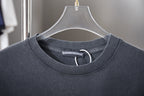 Dark gray crewneck T-shirt collar with woven brand tag