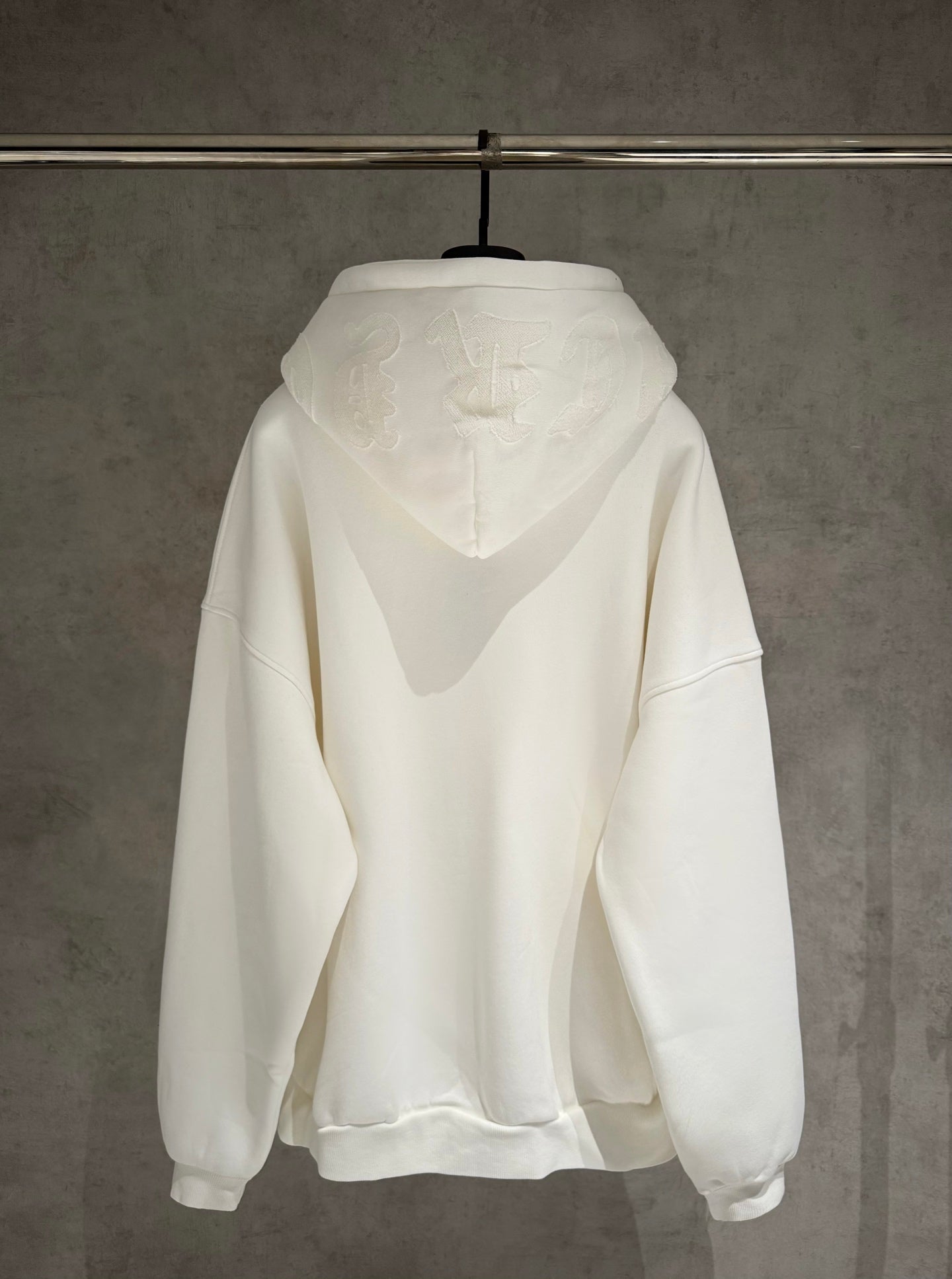 White zip-up hoodie with hood and kangaroo pocket; back view shows no chest logo