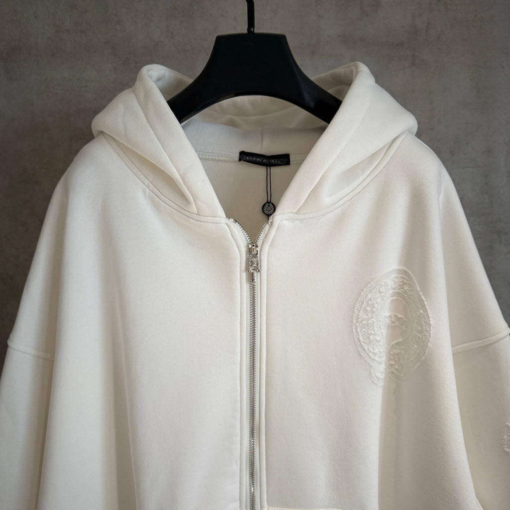 White zip-up hoodie with hood, silver-tone zipper and textured oval chest patch