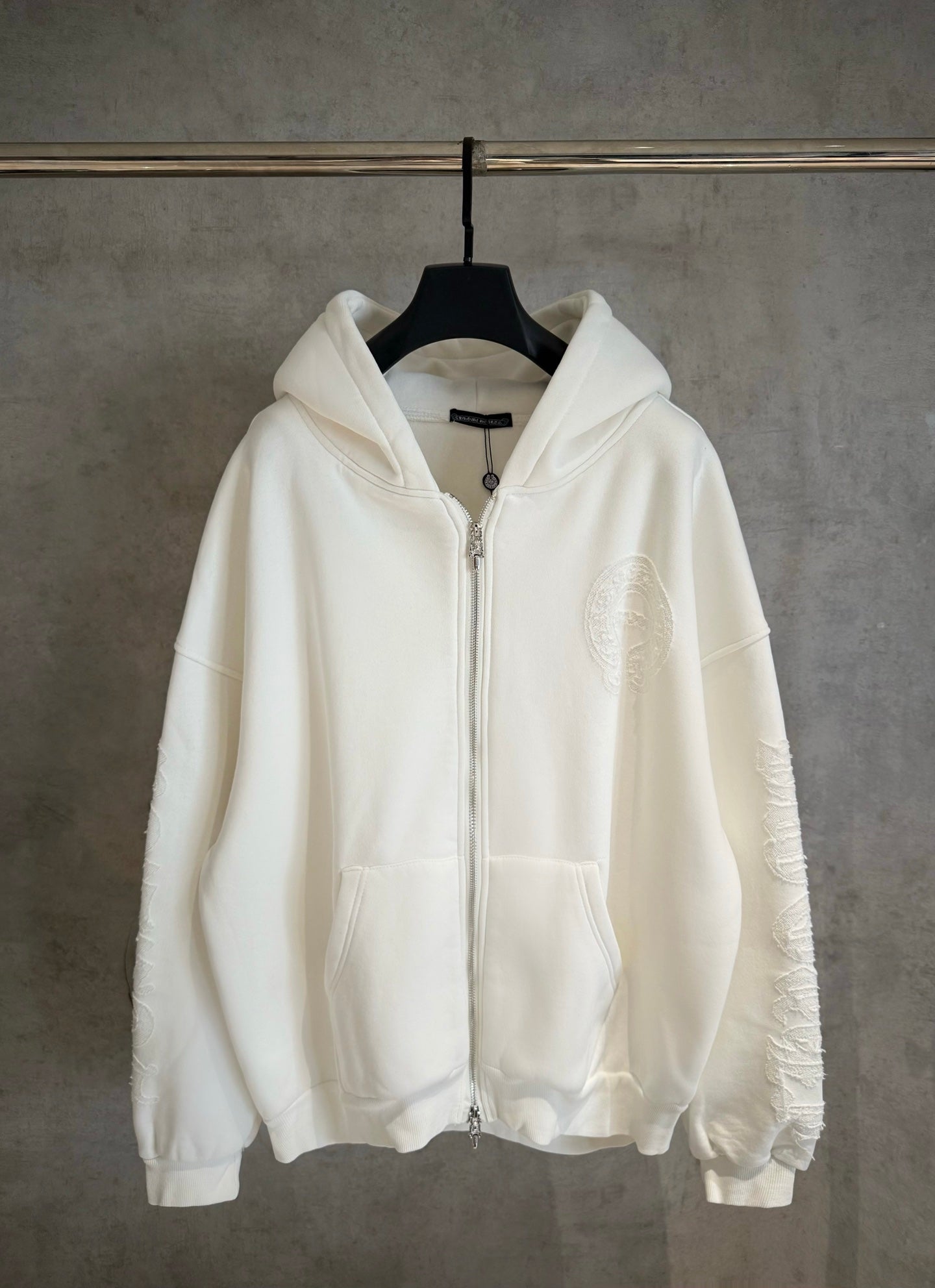 White zip-up hoodie with hood, full-length front zipper and front kangaroo pocket