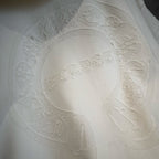 White hoodie close-up of textured oval graphic on front