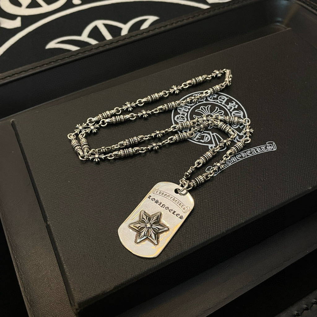 Necklace set with silver-tone chains and rectangular star pendant on dark box