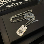 Necklace set with silver-tone chains and rectangular star pendant on dark box