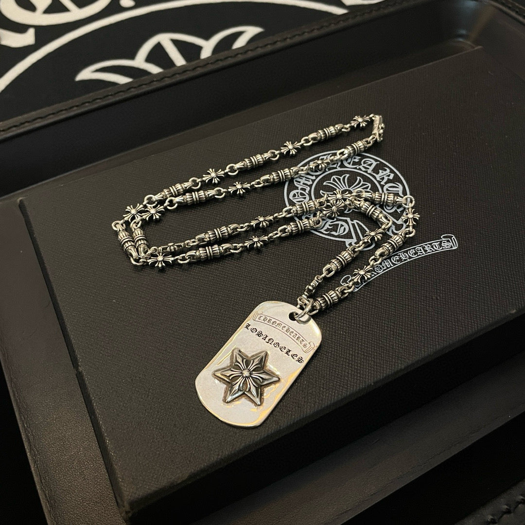 Necklace set with silver-tone chains and rectangular star pendant on dark box