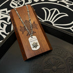 Necklace with silver-tone chain and rectangular star pendant on wooden display card
