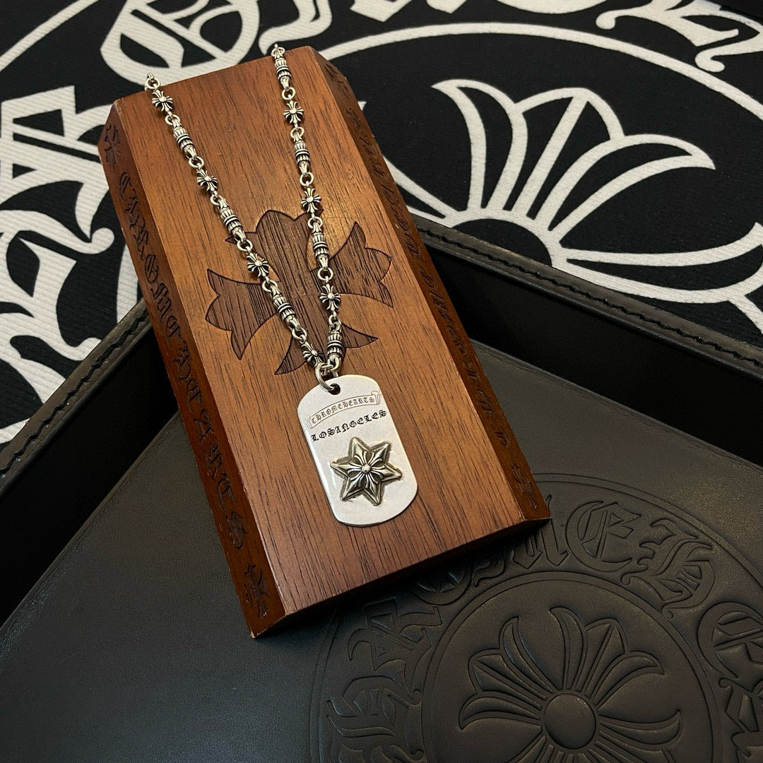 Necklace with silver-tone chain and rectangular star pendant on wooden display card