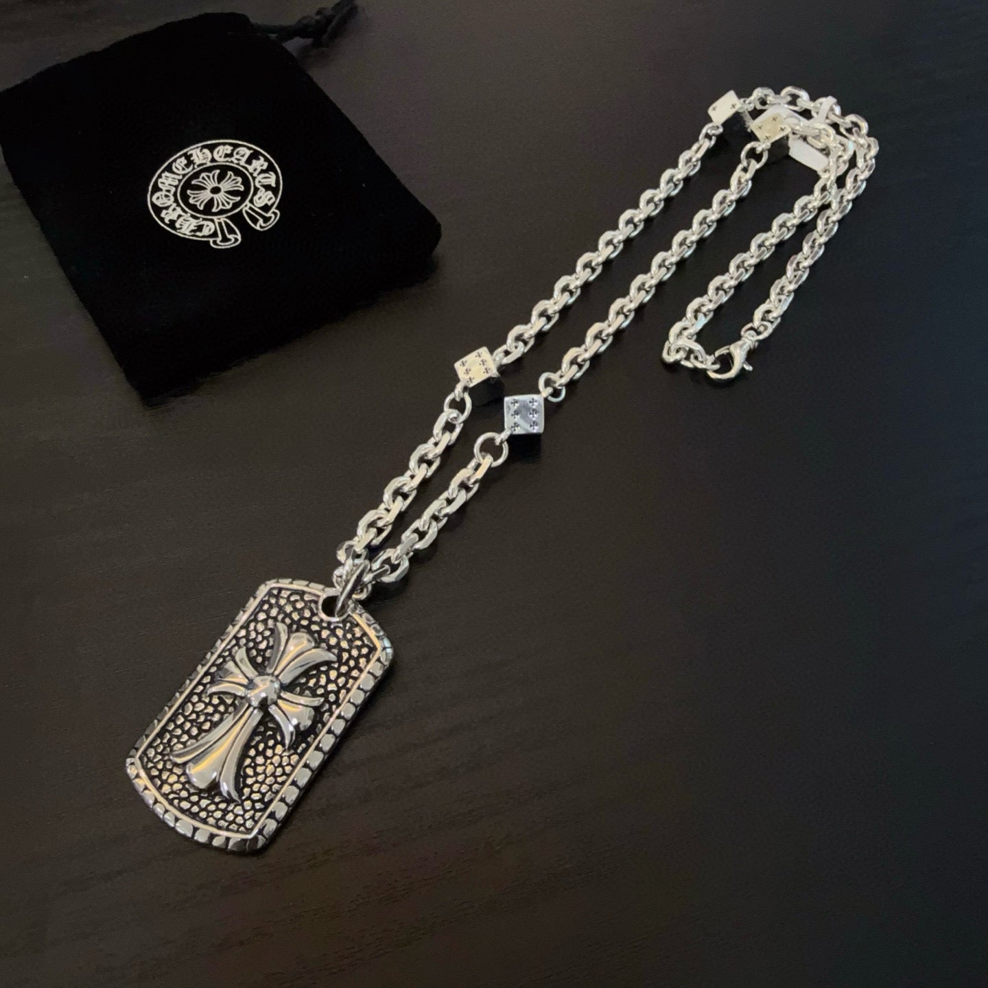 Silver-tone chain necklace with rectangular cross pendant and matching chain length