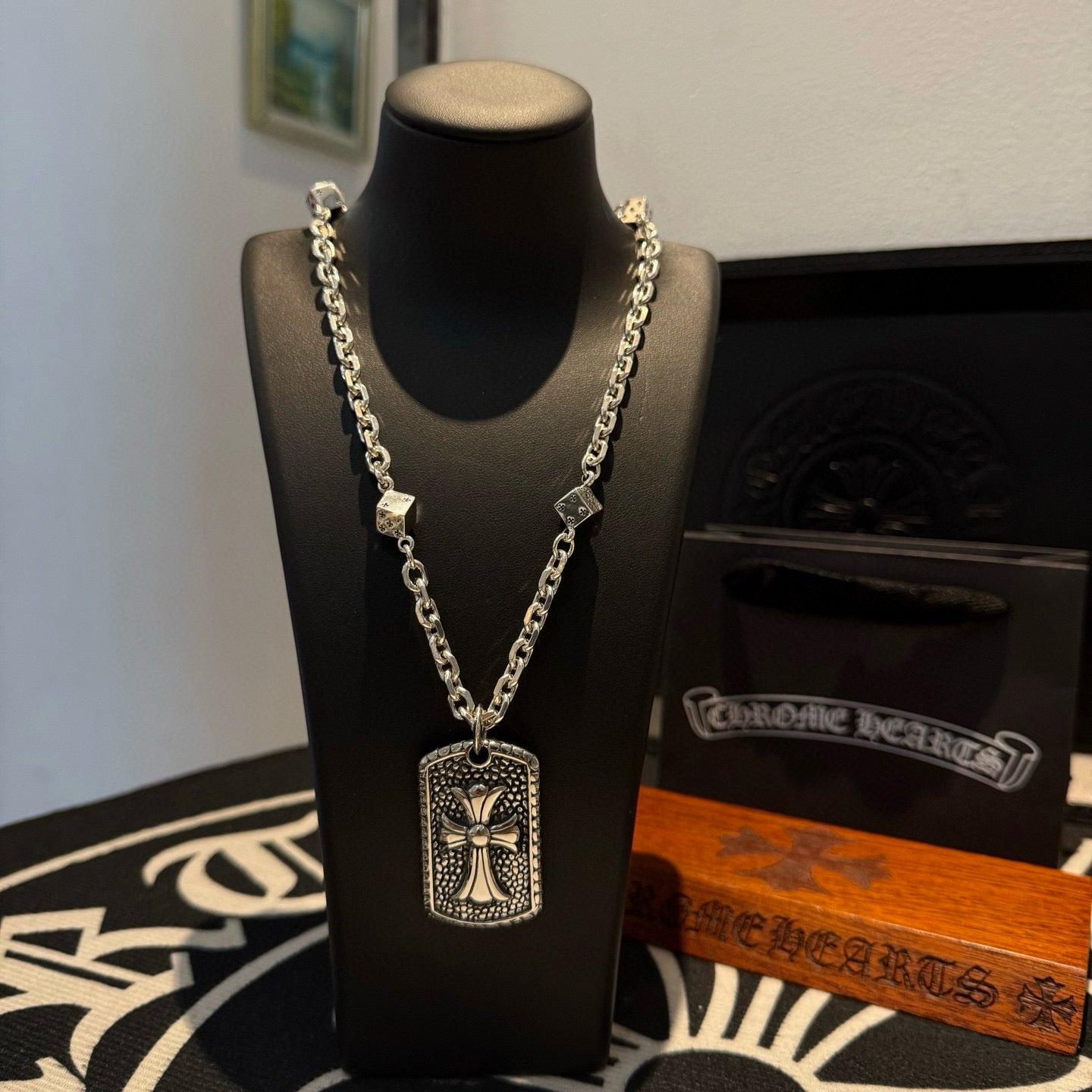 Silver-tone chain necklace with rectangular cross pendant and small connector charms