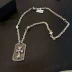 Silver-tone chain necklace with rectangular cross pendant and small charm tags