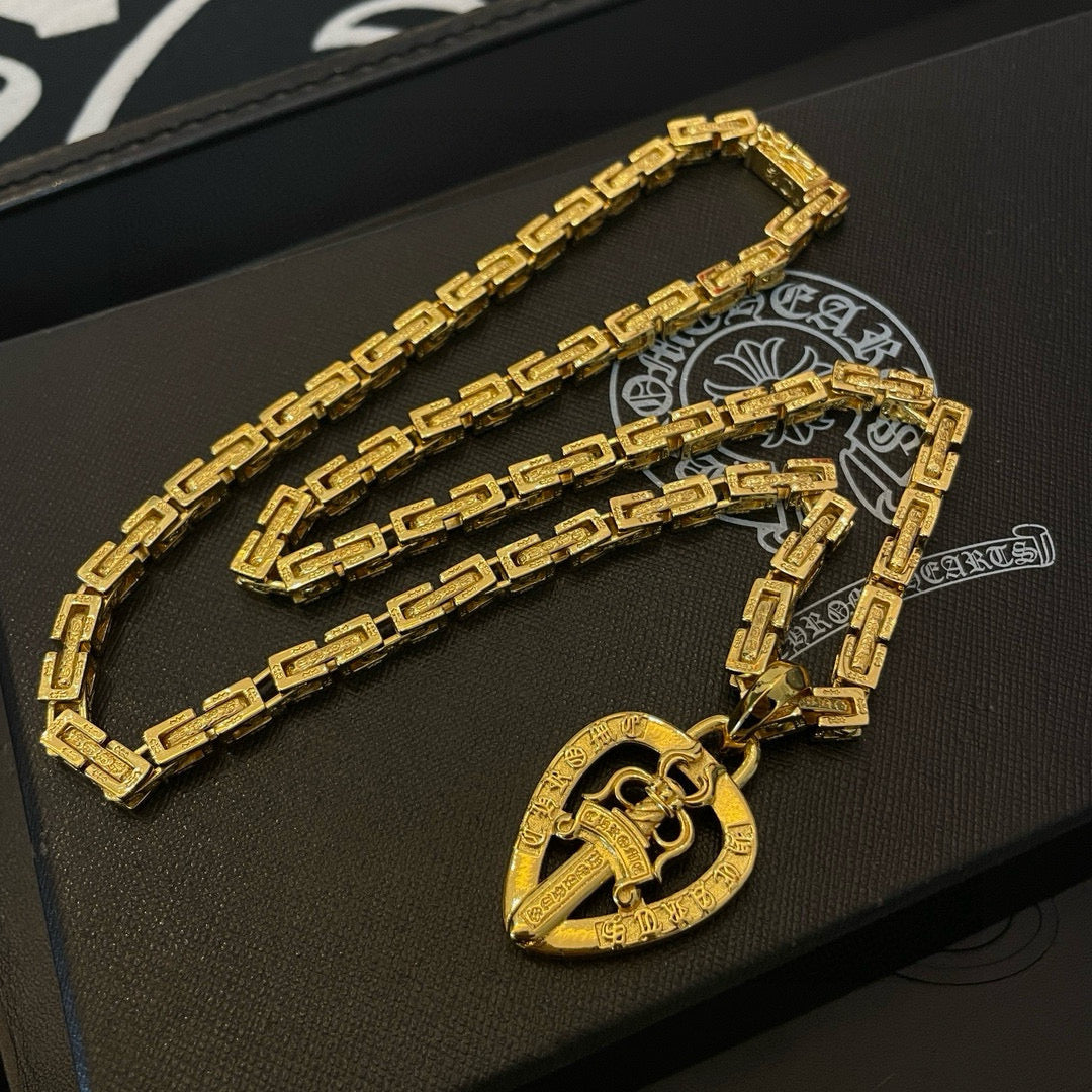 Gold-tone long necklace with teardrop pendant charm on black gift box