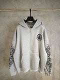Light gray zip-up hoodie with black ornate sleeve prints and chest emblem