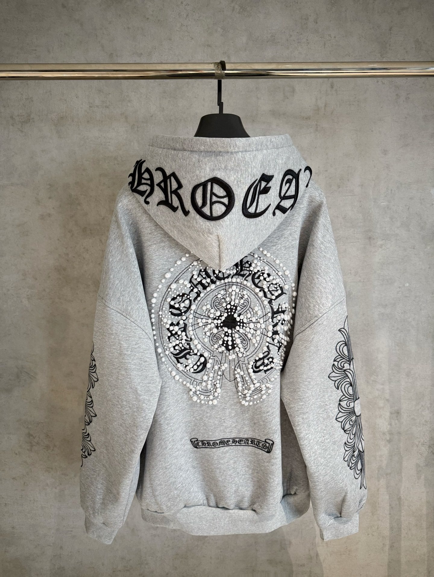 Light gray zip hoodie with large back graphic and rhinestone-style angel emblem