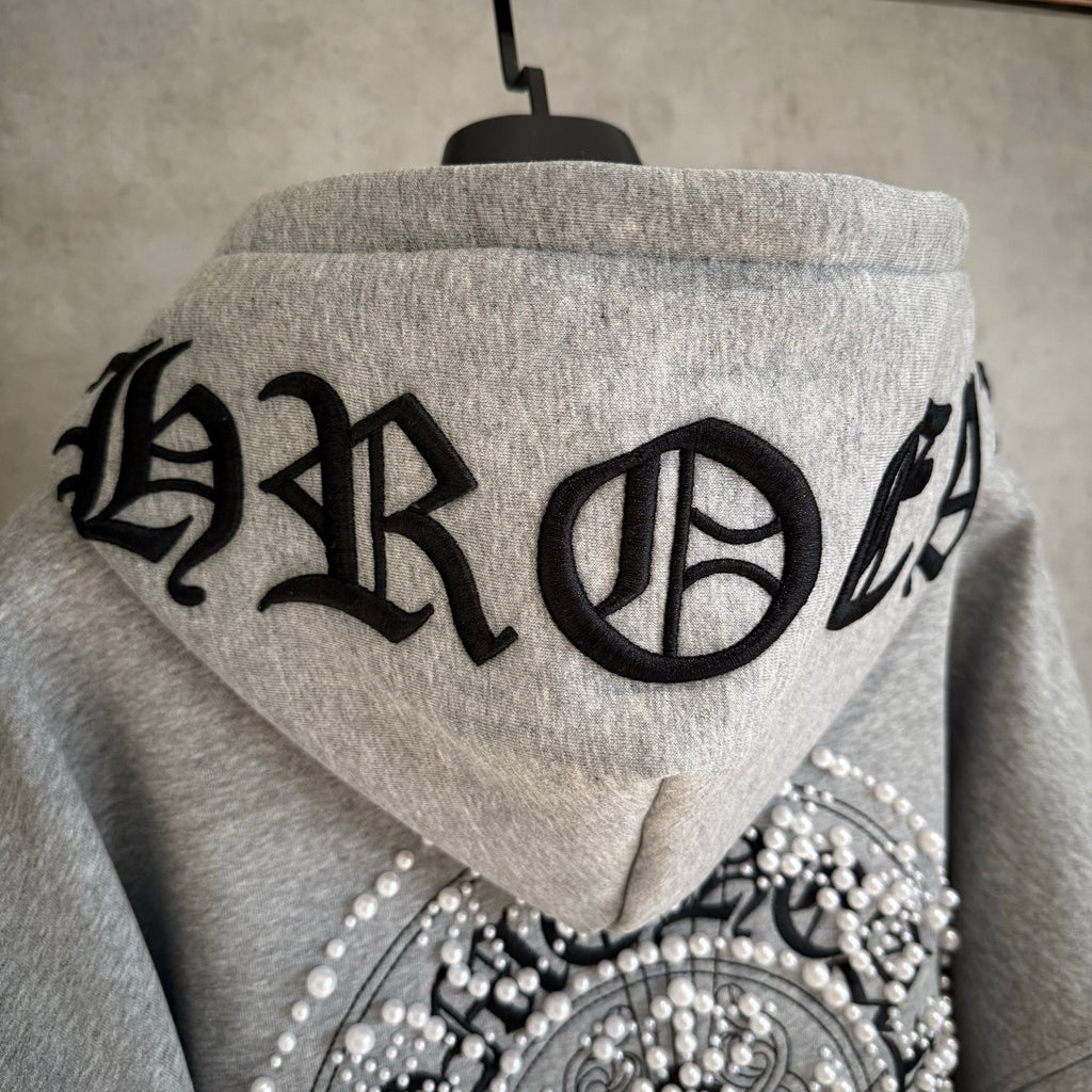 Light gray hoodie back hood with large black lettering and jeweled heart panel
