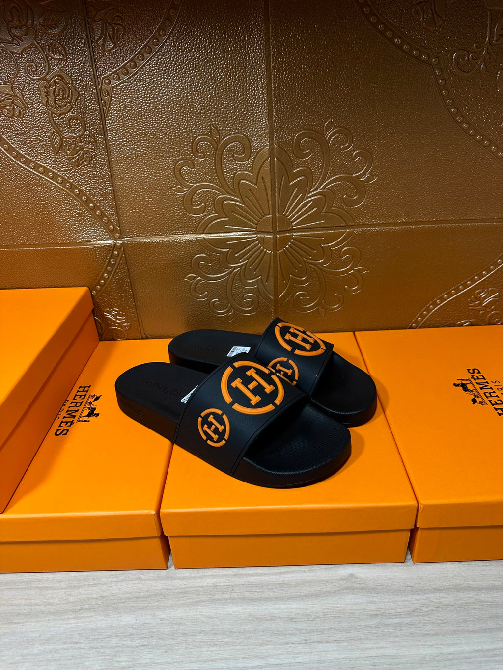 Hermes black slide sandals with orange logo strap band