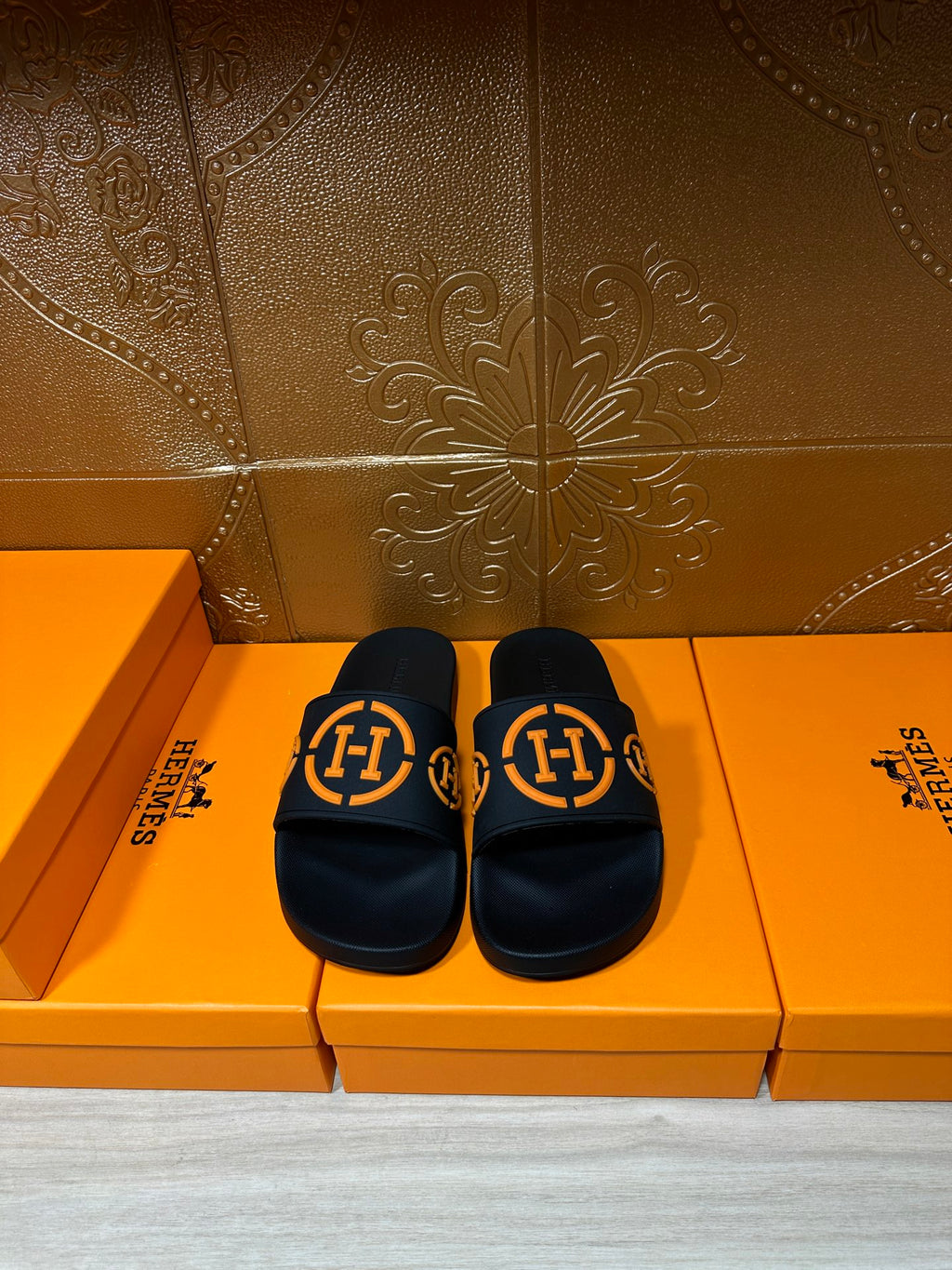 Hermes black slide sandals with orange double-H logo straps