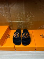 Hermes black slide sandals with orange double-H logo straps