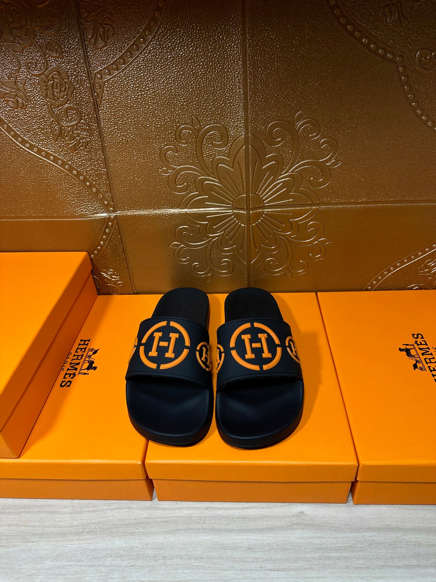 Hermes black slide sandals with orange double-H logo straps