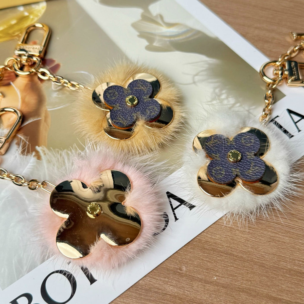 Louis Vuitton keychain charm pair with blue flower charms and pink fur