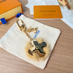 Louis Vuitton flower charm keychain with blue leather, gold chain, and faux fur trim