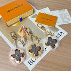 Louis Vuitton charm keychains set with blue flower leather, faux fur, and gold chains