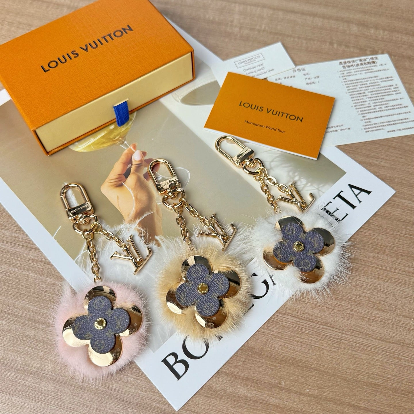 Louis Vuitton charm keychains set with blue flower leather, faux fur, and gold chains