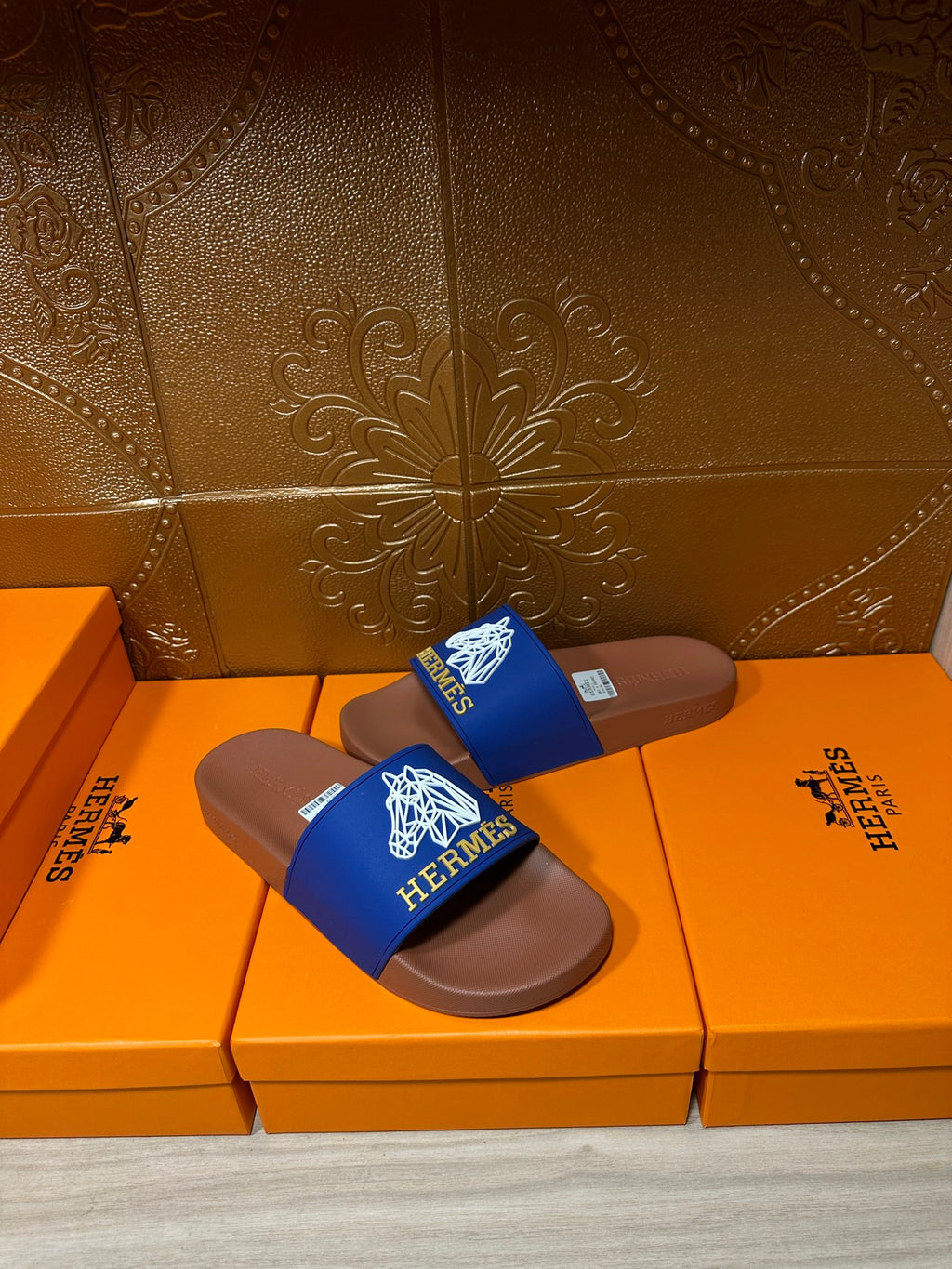 Hermes slide sandals, single pair view with blue logo strap on brown footbed