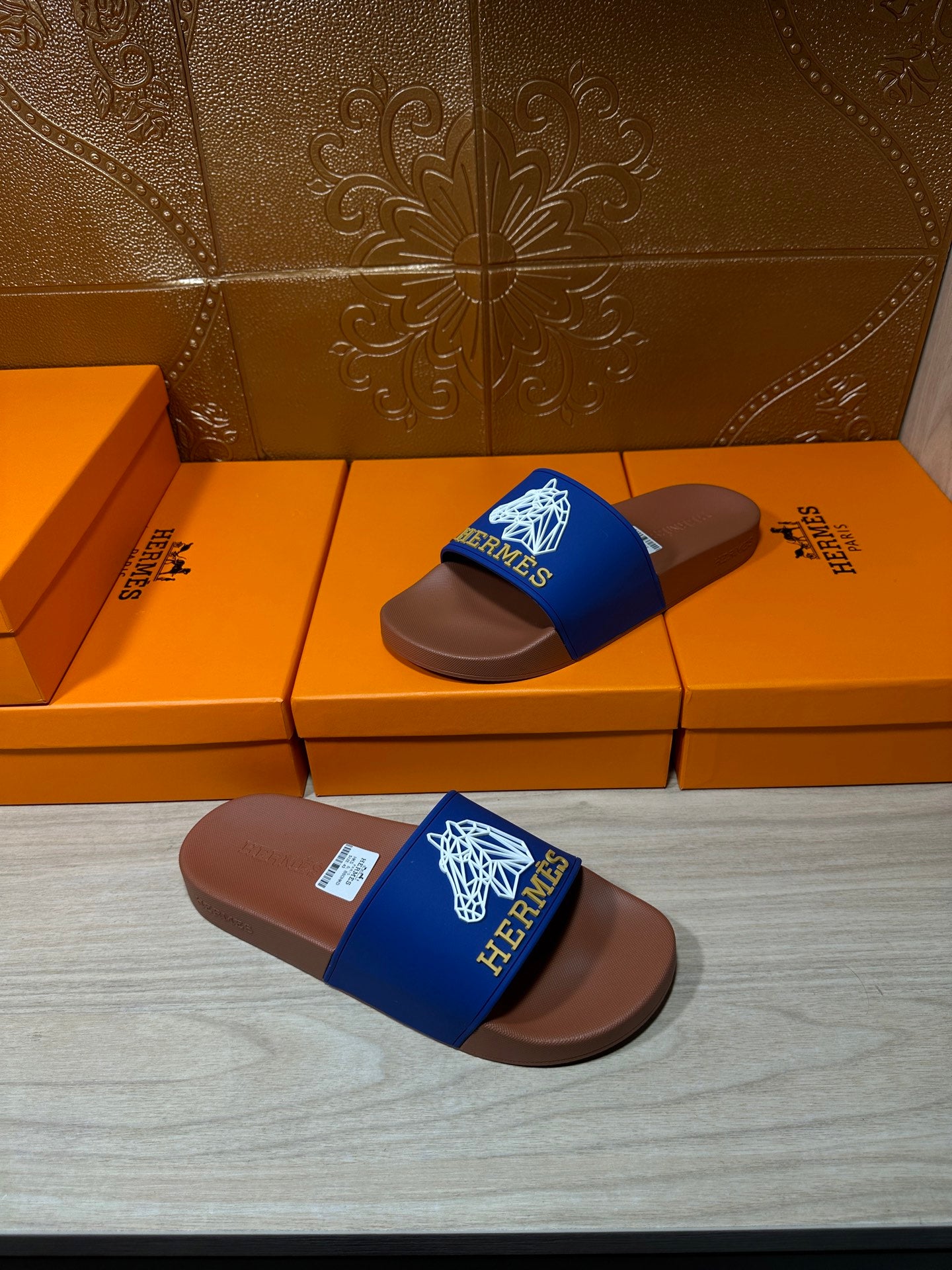 Hermes slide sandals on boxes: blue logo strap with brown footbed
