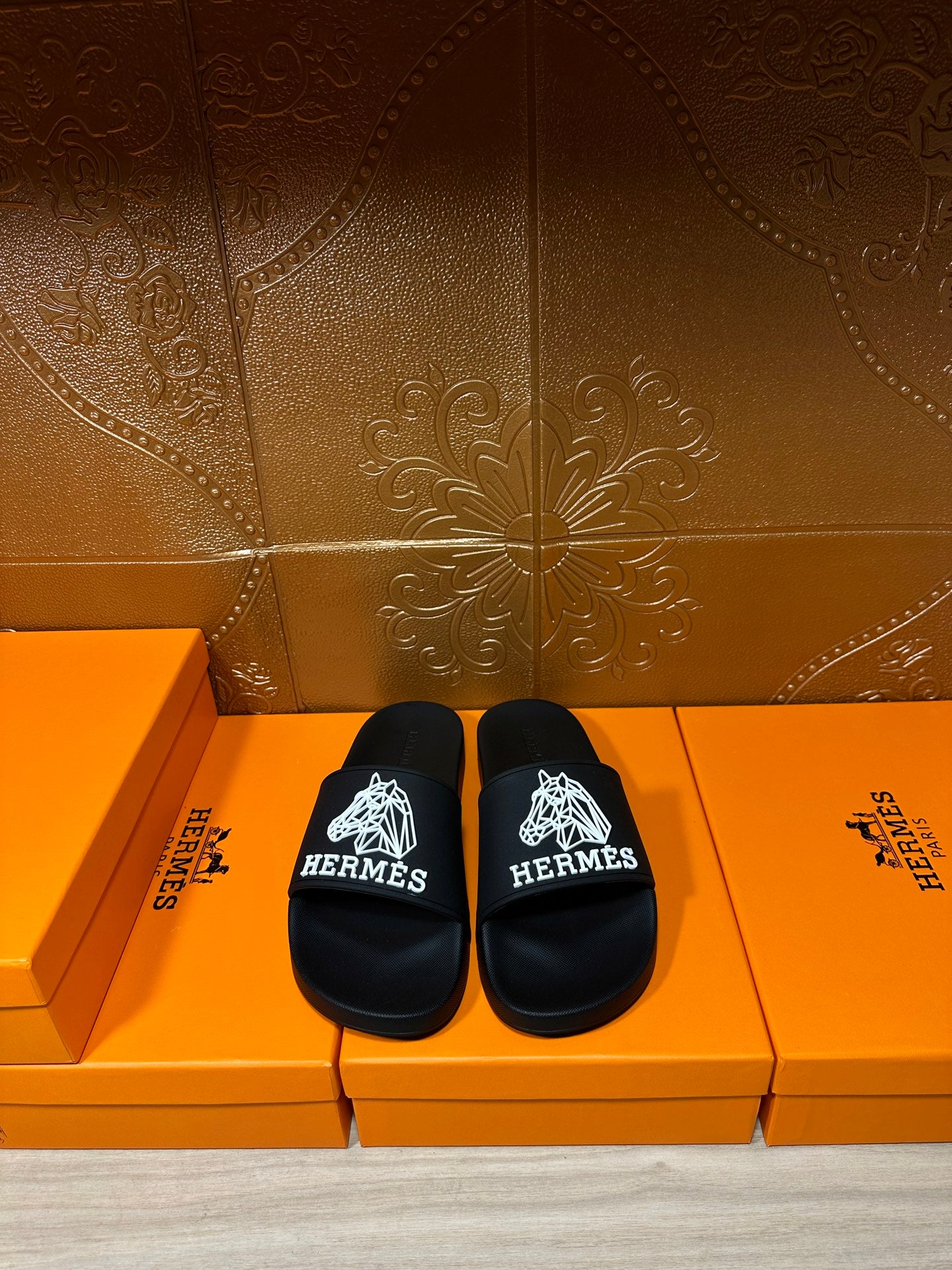 Hermes black slide sandals with wide strap and white logo print