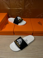 Hermes slide sandals pair, white footbed with black band and geometric emblem