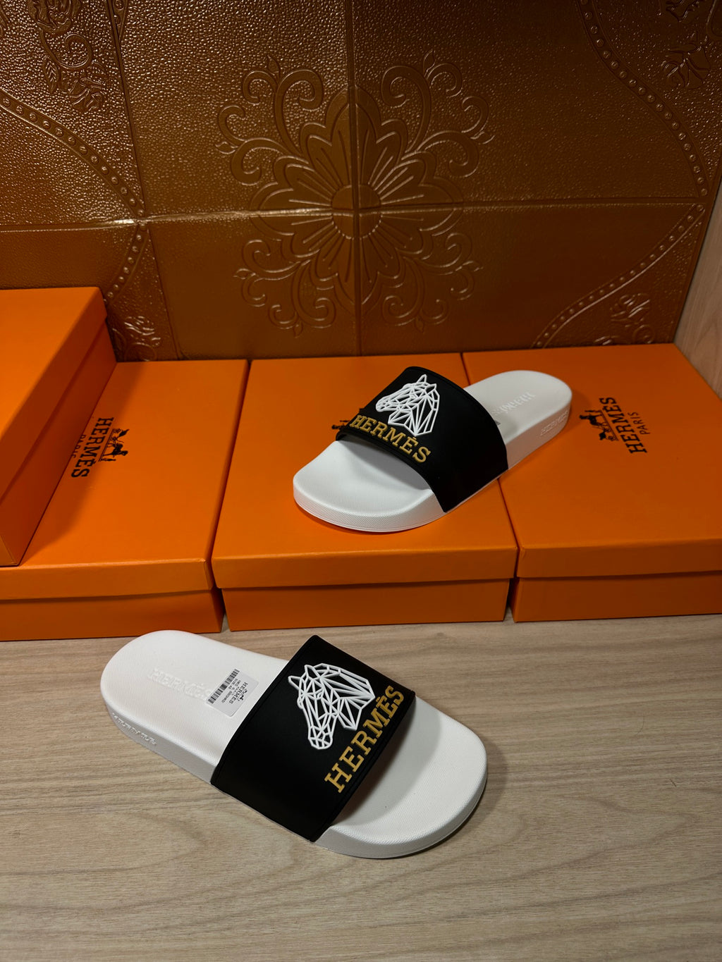 Hermes slide sandals, black strap with white emblems on white contoured footbed