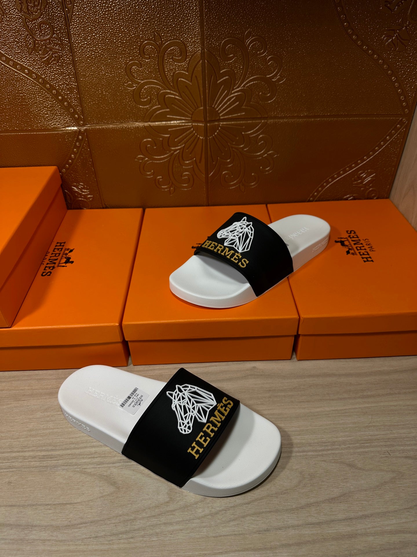 Hermes slide sandals, black strap with white emblems on white contoured footbed