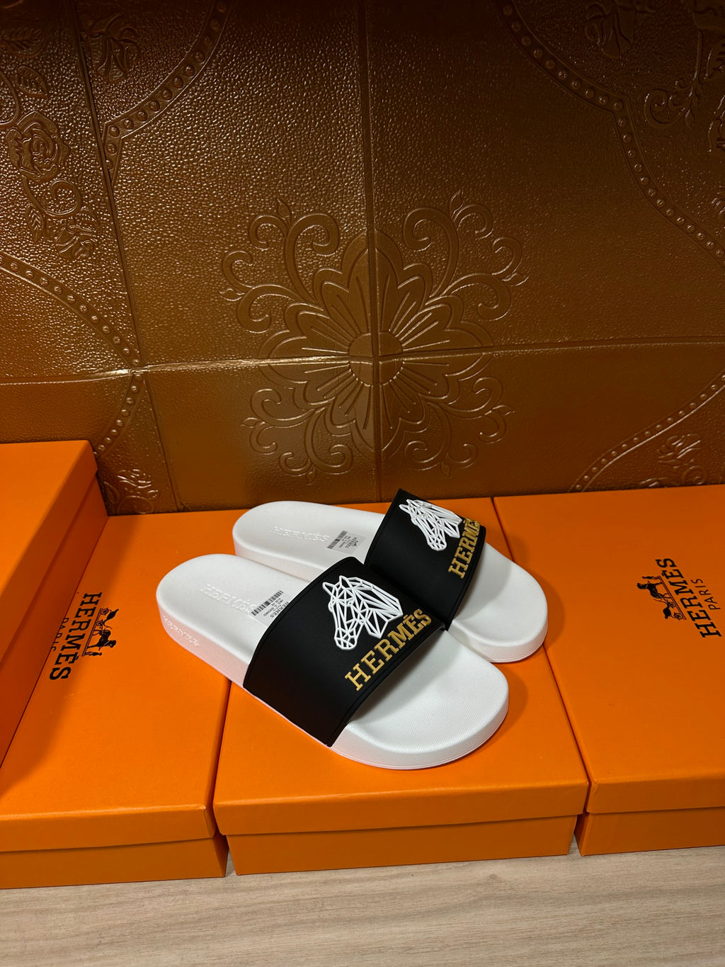 Hermes slide sandals pair, white footbed with black band and white emblem details