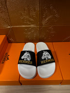 Hermes slide sandals with white footbed and black logo strap