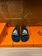 Navy slide sandals with white HERMES logo on wide strap