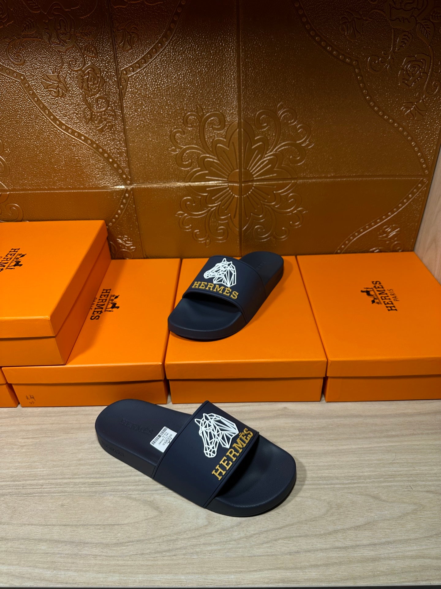 Navy slide sandals with white HERMES logo on front strap