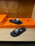 Navy slide sandals with white HERMES logo on strap and footbed