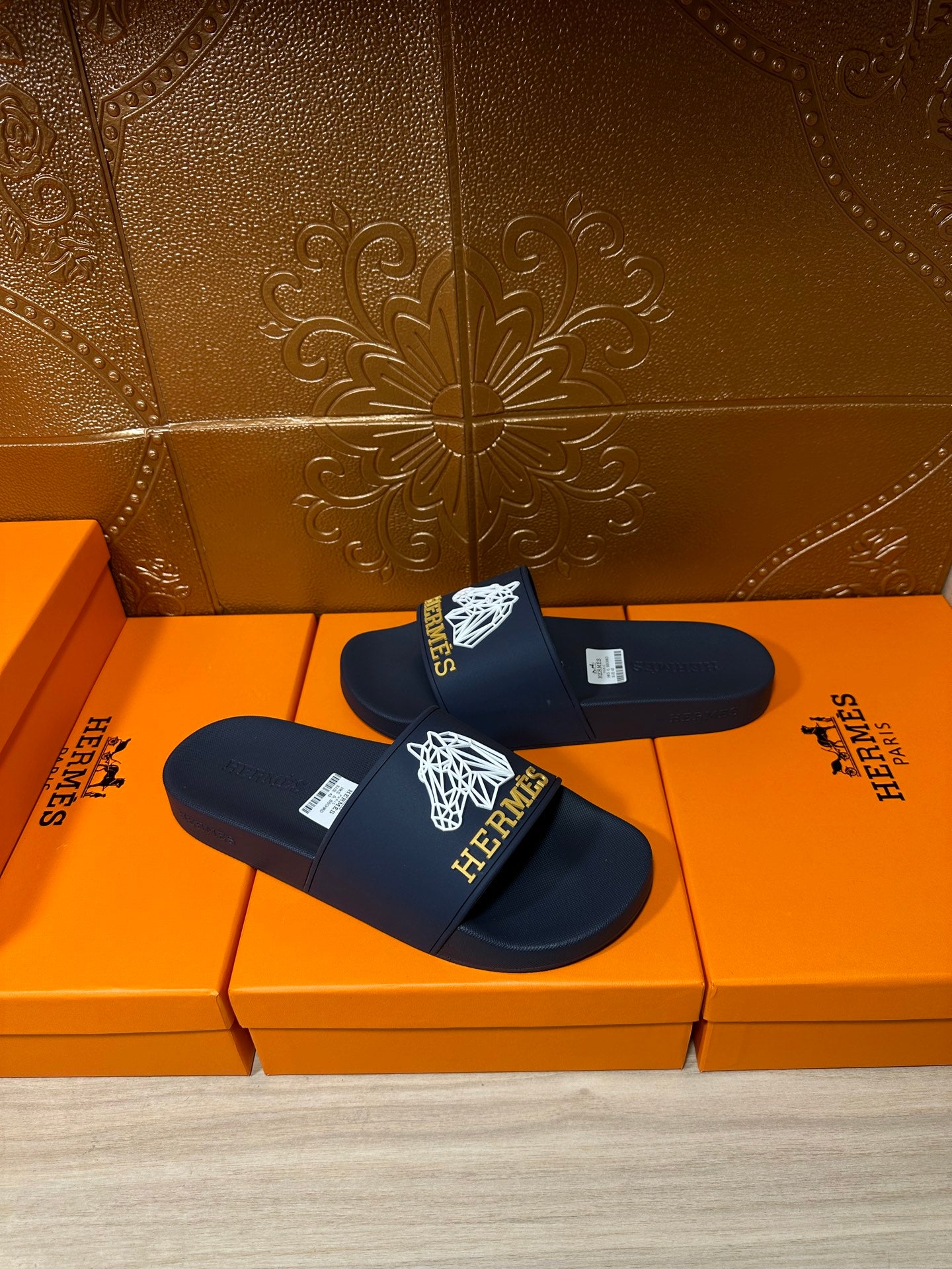 Navy slide sandals with white HERMES logo and wide single strap