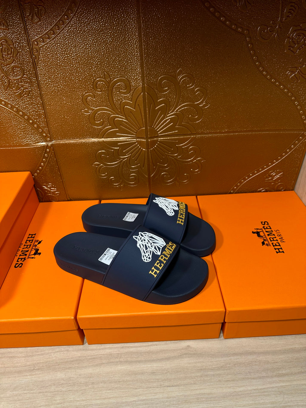 Navy slide sandals with white HERMES logo on front strap