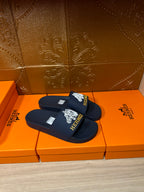 Navy slide sandals with white HERMES logo on front strap