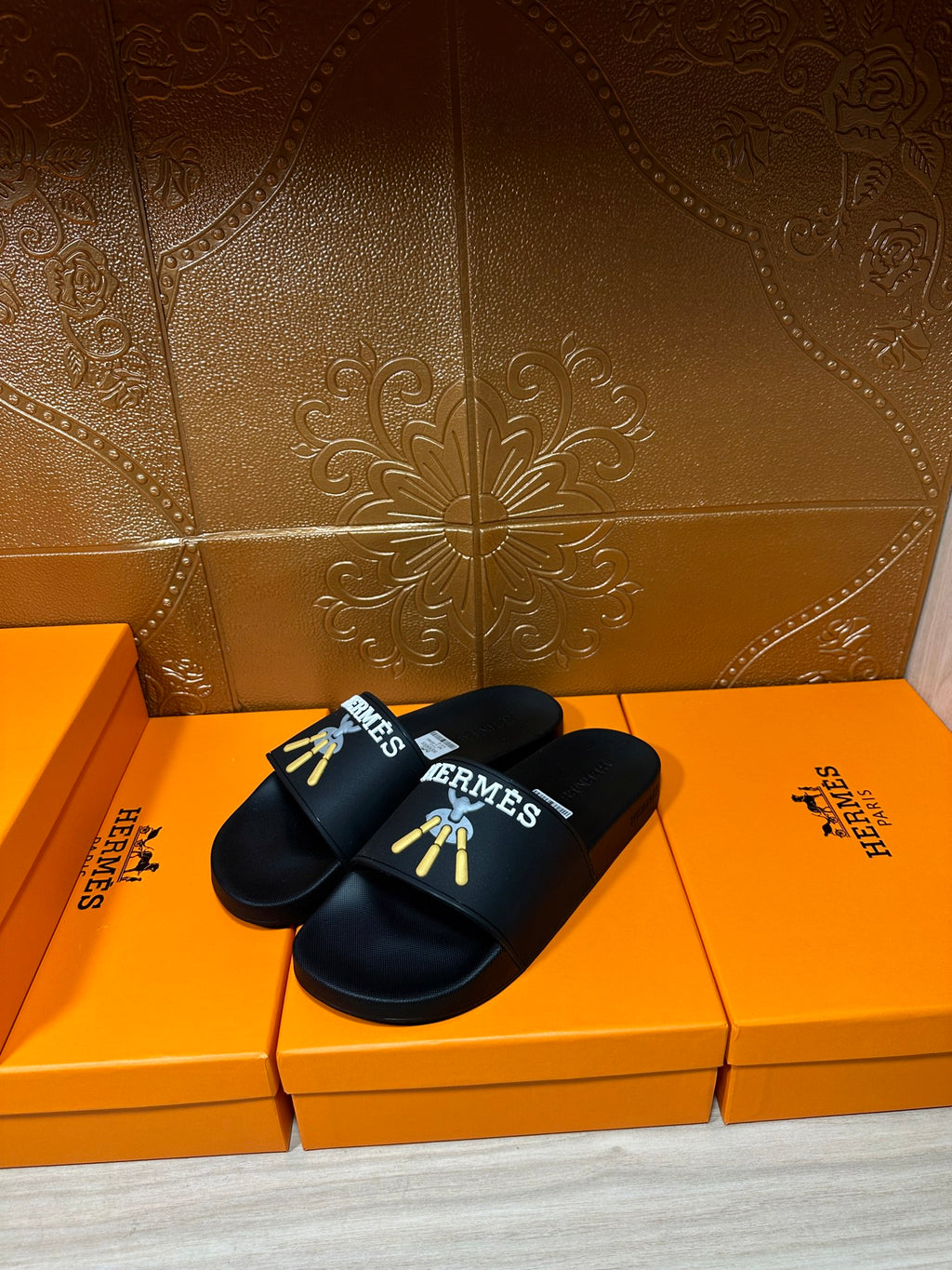 Hermes black slide sandals, gold logo detail on front strap