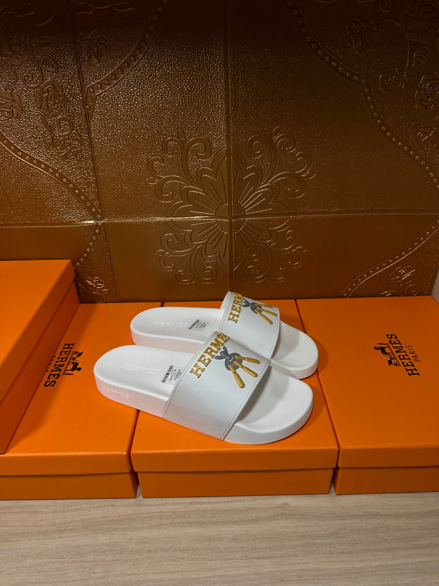 White Hermes slide sandals, single wide strap with gold logo detail