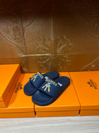 Hermes blue slide sandals, double strap with gold HERMES text and charm graphic