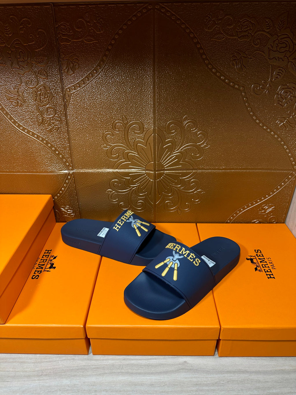Hermes blue slide sandals, strap with gold HERMES logo and charm graphic