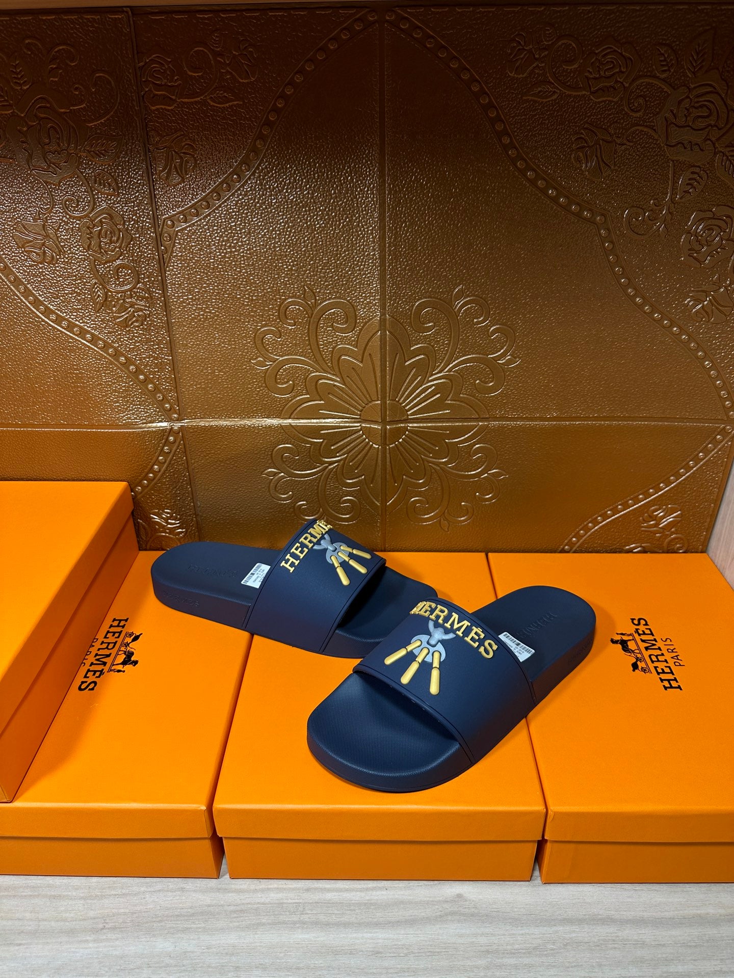 Hermes blue slide sandals, strap with gold HERMES logo and charm graphic
