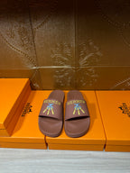 Hermes slide sandals in taupe with multicolor logo patch and open-toe design