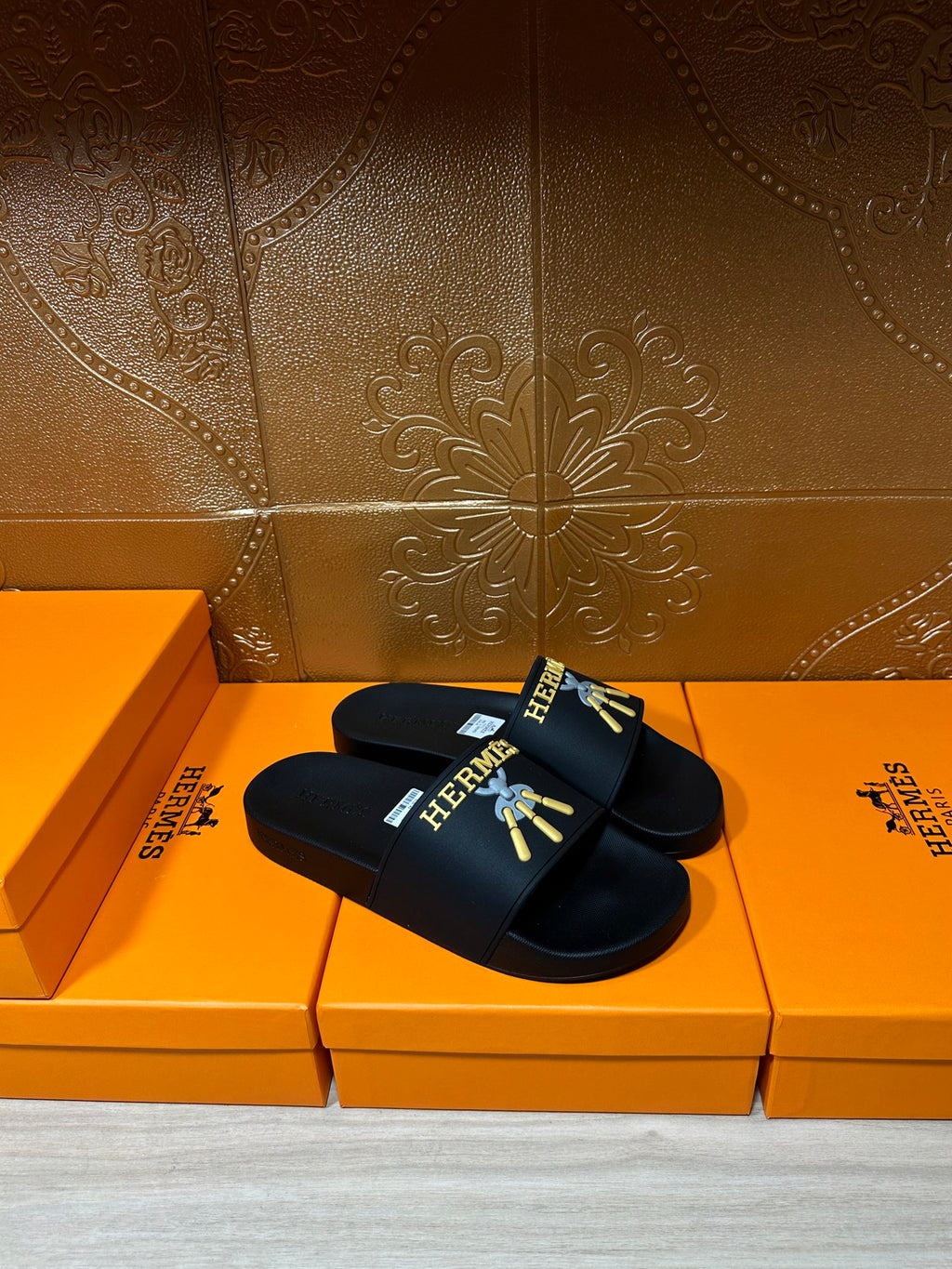Hermes slide sandals, black sandal slides with logo print across the front strap.