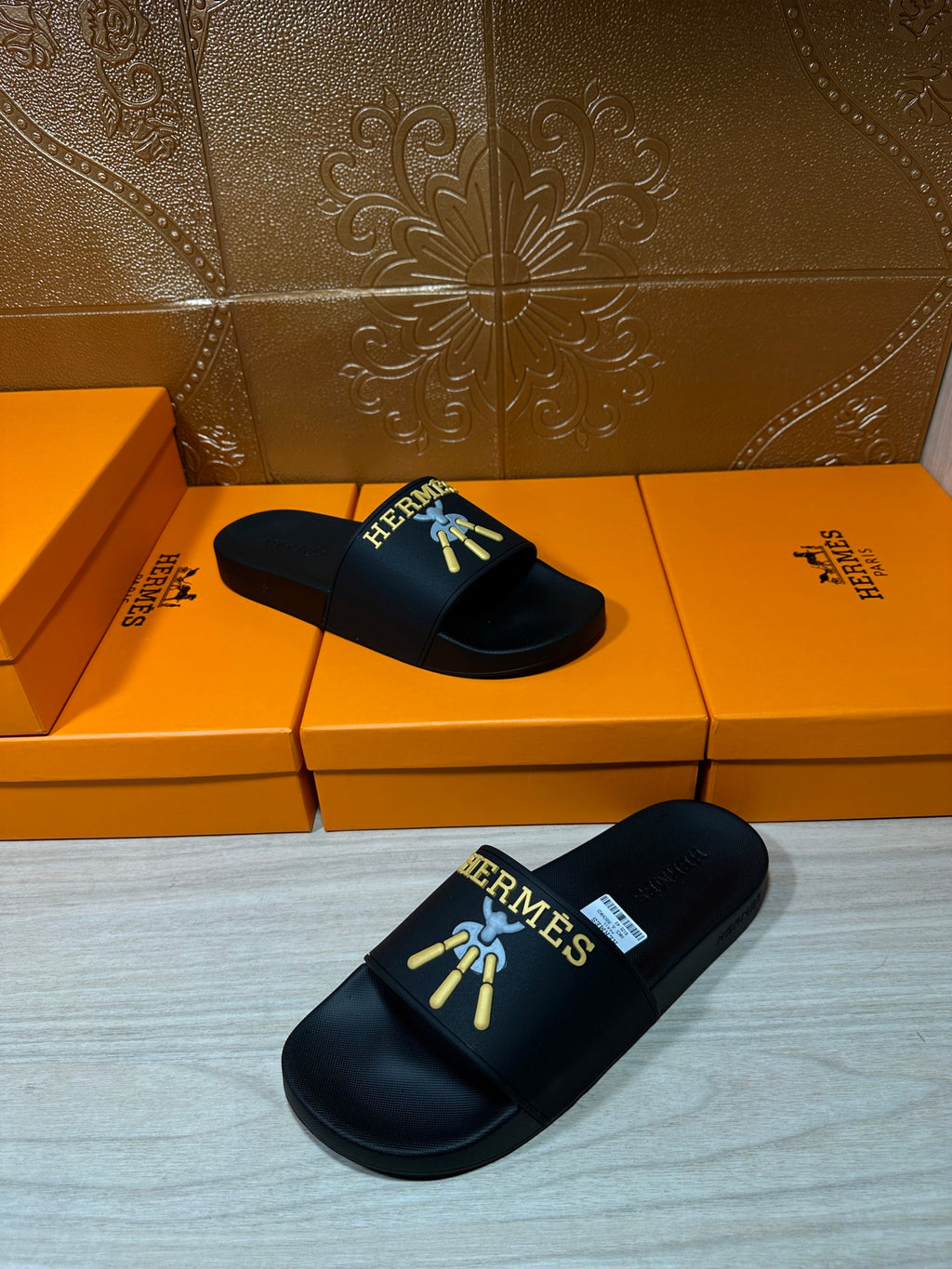 Hermes slide sandals, black slides with logo detail on the front and footbed.