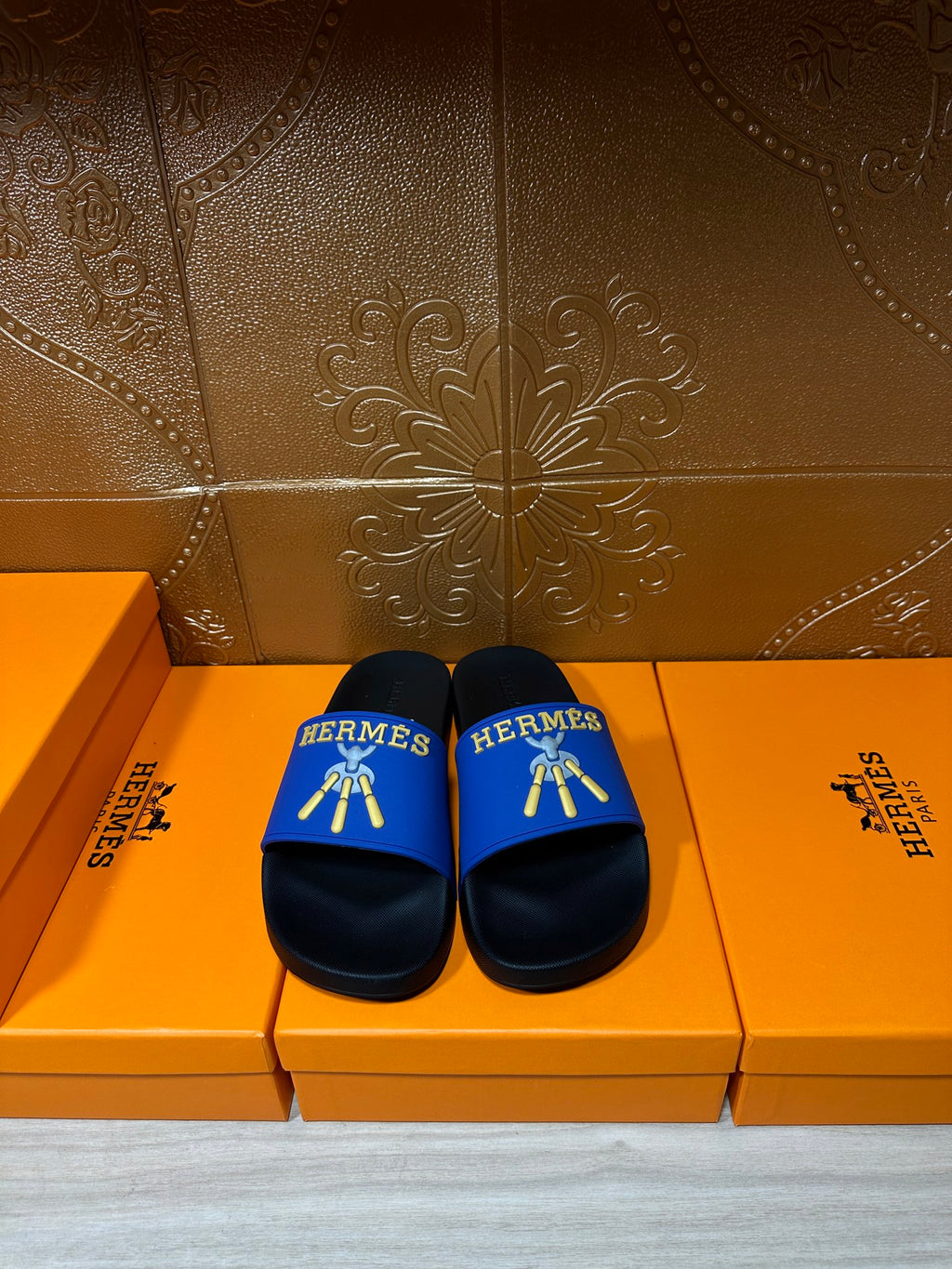 Hermes slide sandals with blue strap, black footbed and gold logo detail