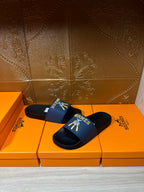 Hermes slide sandals, blue band with gold Hermes motif on dark footbed