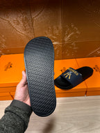 Hermes slide sandals outsole view, textured black sole underside